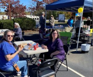 Asheville employees enjoy hot dogs in the parking lot