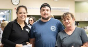 Asheville employees pose with NIB representative Gigi following the hurricane