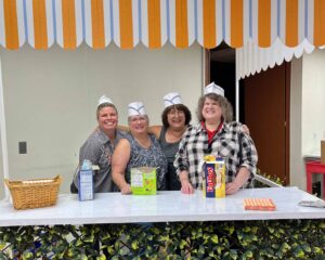 Employees serving ice cream at the 90th anniversary ice cream bar event at the Winston-Salem facility.