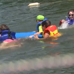 SEE Campers enjoy swimming in a lake