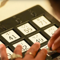 Woman uses a braille bingo card