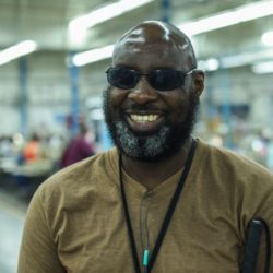Photo of Roderick smiling inside the IFB Solutions manufacturing facility in Winston-Salem, NC