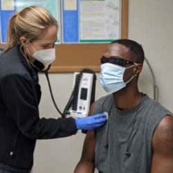 Nurse checks the breathing of a man
