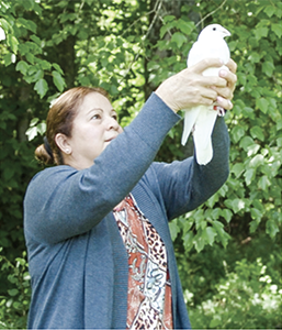 woman holding a dove outdoors