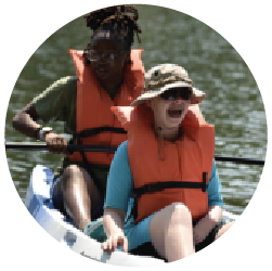 two young women in a canoe wearing life jackets