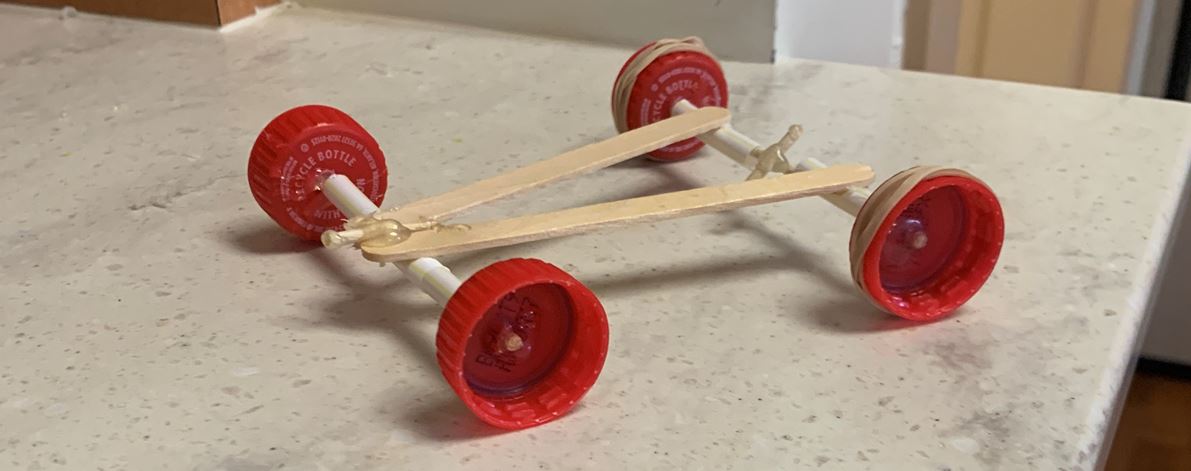 racer made from popsicle sticks and bottle caps.