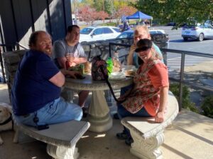 Asheville employees enjoy hotdogs on the covered patio