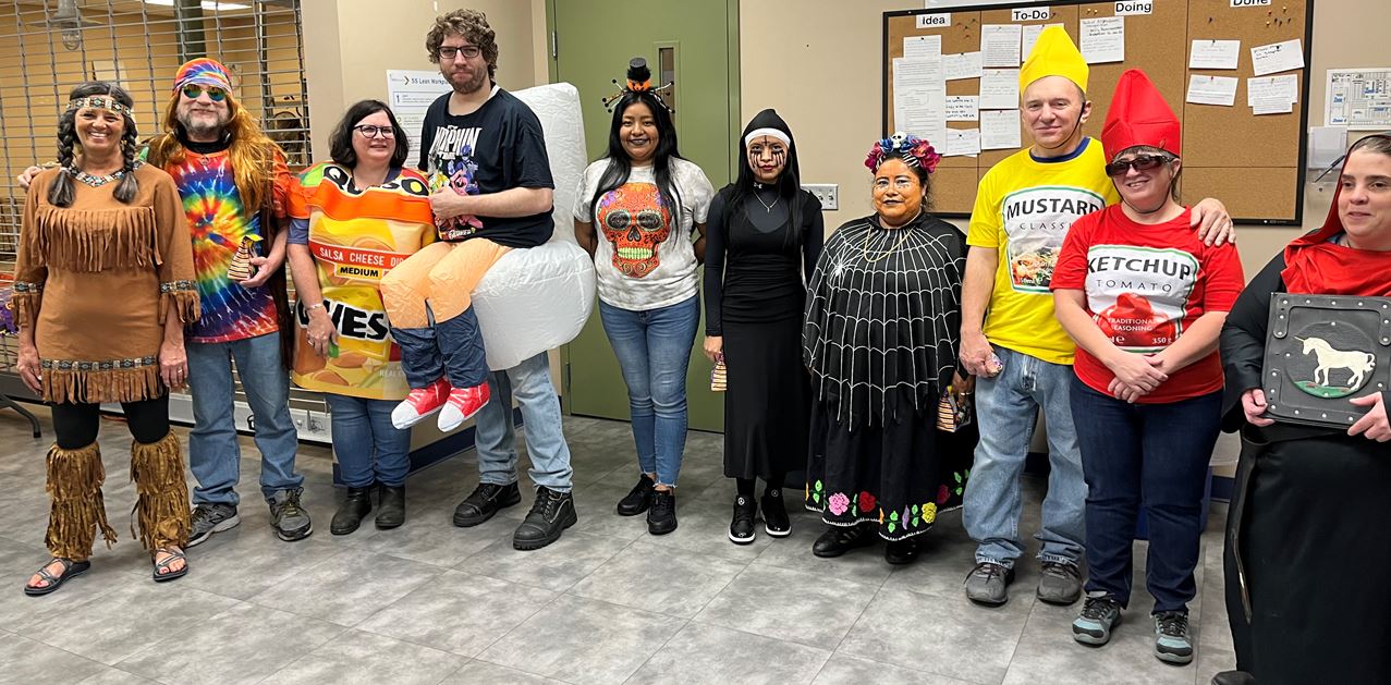 Asheville employees pose in their Halloween costumes.