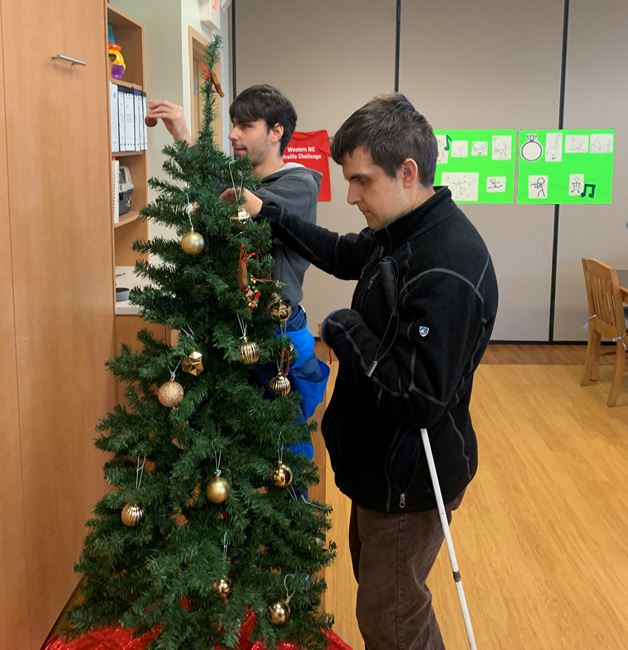 S.E.E. students add ornaments to their tree