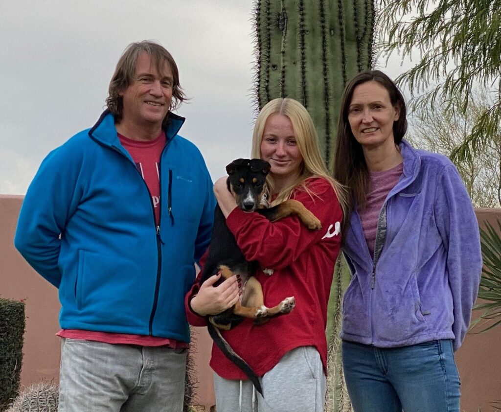 Heather Robinson with husband Eric, daughter Hannah, and rescue dog Devin. 