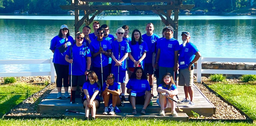 campers and staff outside at Camp Dogwood all wearing royal blue Camp Abilities NC T-shirts