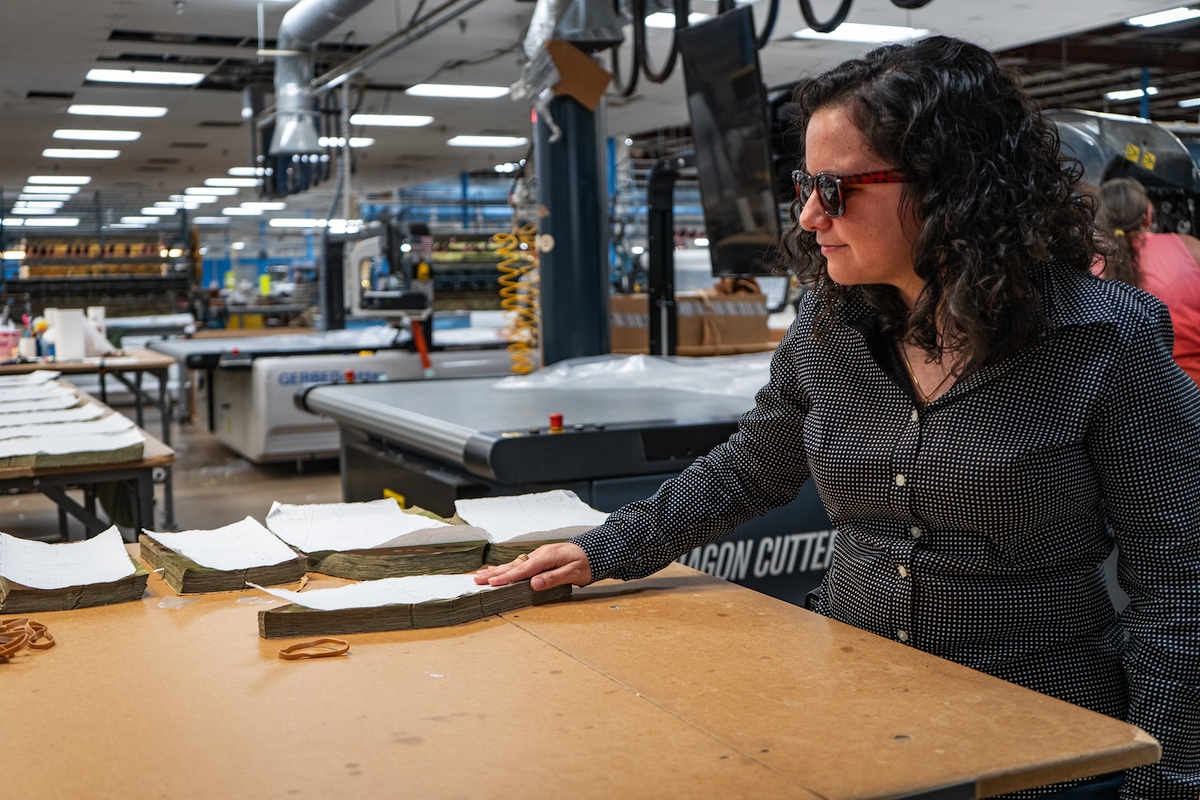 Alina Garcia Ravelo inspects military–specified laser cut fabric at IFB's Asheville manufacturing facility.