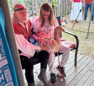 S.E.E. student pets a fluffy goose