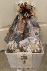 Happy Thanksgiving gift basket with fall-themed household items and treats