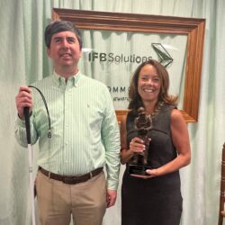 Dan Kelly poses with Laura Burrows holding Commodore Statuette