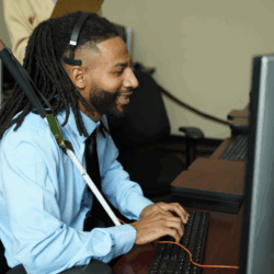 Marvin, a customer service representative who is blind, works at his computer.