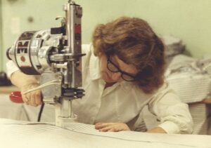 An IFB employee using a sewing machine in the 1950s.