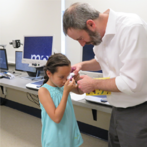 Grant works with a child as part of the Focus on Literacy Program
