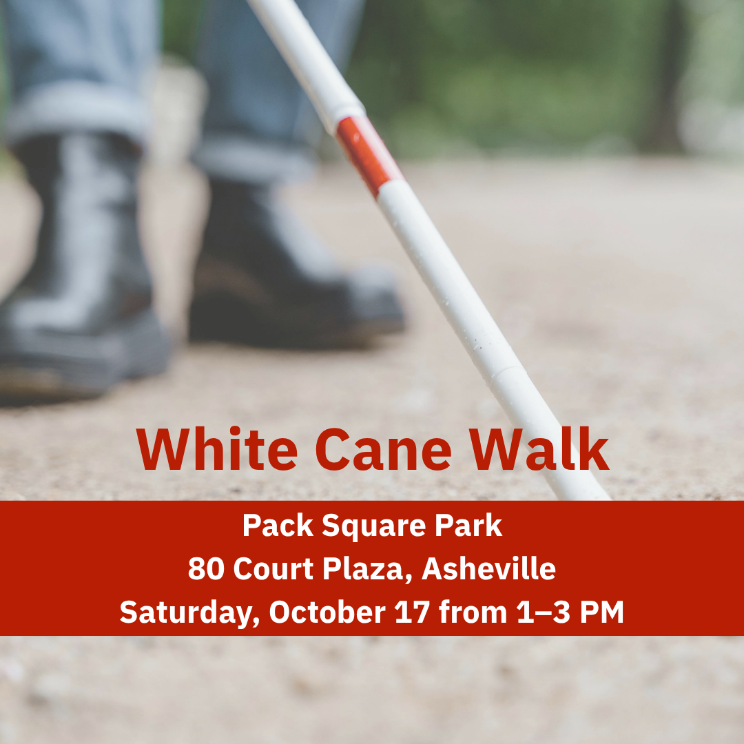 A person's boots, and the end of a white cane that they are using.